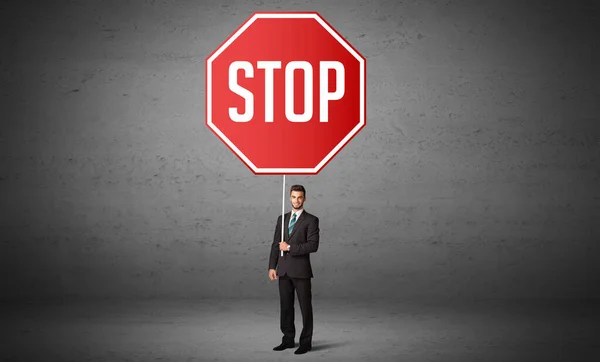 Young business person holding road sign — Stock Photo, Image