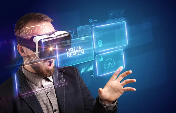 Businessman looking through Virtual Reality glasses, tech concept — Stock Photo, Image