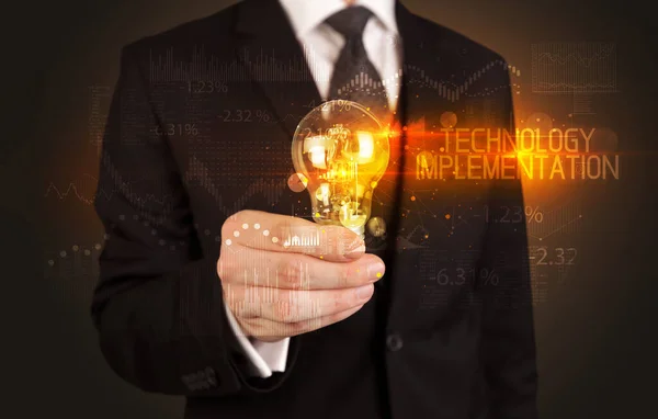 Businessman holding a lightbulb concept — Stock Fotó