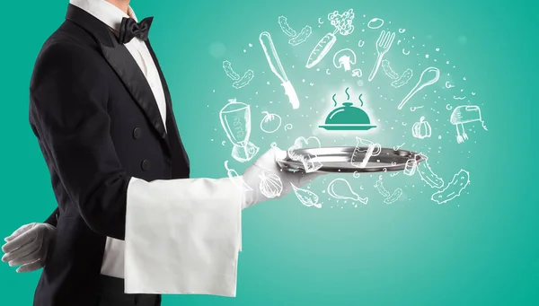 Waiter holding silver tray with food icons above — Stock Photo, Image