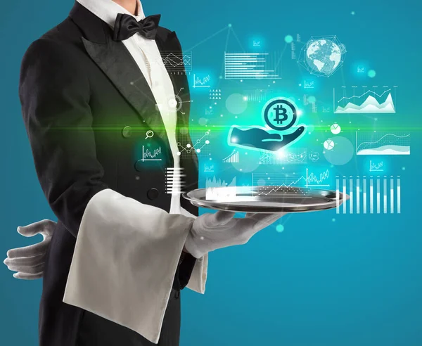 Handsome young waiter in tuxedo holding currency icons on tray — Stock Photo, Image