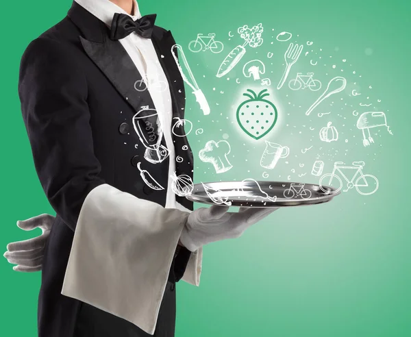 Waiter holding silver tray with food icons above — Stock Photo, Image