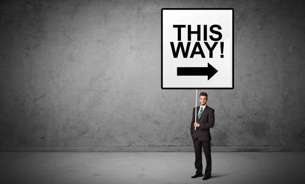 Business person holding a traffic sign concept — Stock Photo, Image