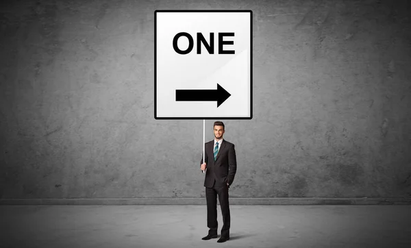 Business person holding a traffic sign — Stock Photo, Image