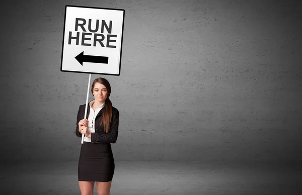 Business person holding a traffic sign — Stock Photo, Image