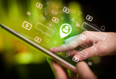 Tablet, sosyal medya kavramı kullanan bir elin yakın plan çekimi