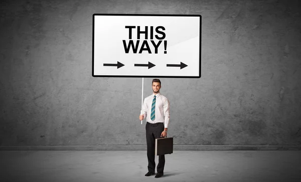 Business person holding a traffic sign concept — Stock Photo, Image