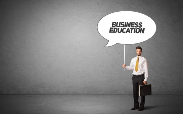 Business person in casual holding road sign — Stock Photo, Image