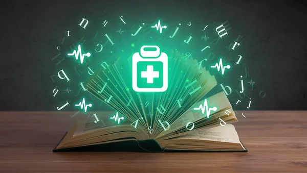 Open medical book with health icons above — Stock Photo, Image