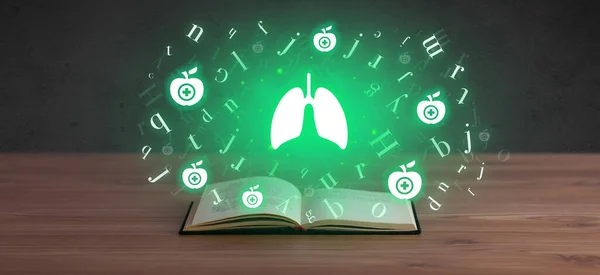 Open medical book with health icons above