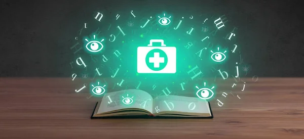 Open medical book with health icons above