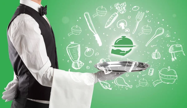 Kelner trzymający srebrną tacę z ikonami żywności powyżej — Zdjęcie stockowe