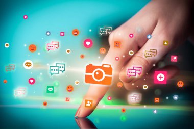 Sosyal medya simgelerine sahip tablet kullanan bir elin yakın plan görüntüsü