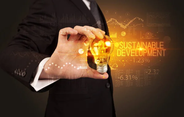 Businessman holding a lightbulb concept — Stock Photo, Image