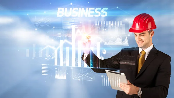 Young businessman with helmet drawing on virutal screen — Stock Photo, Image