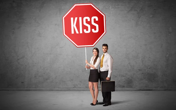 Young business person holding road sign — Stock Photo, Image