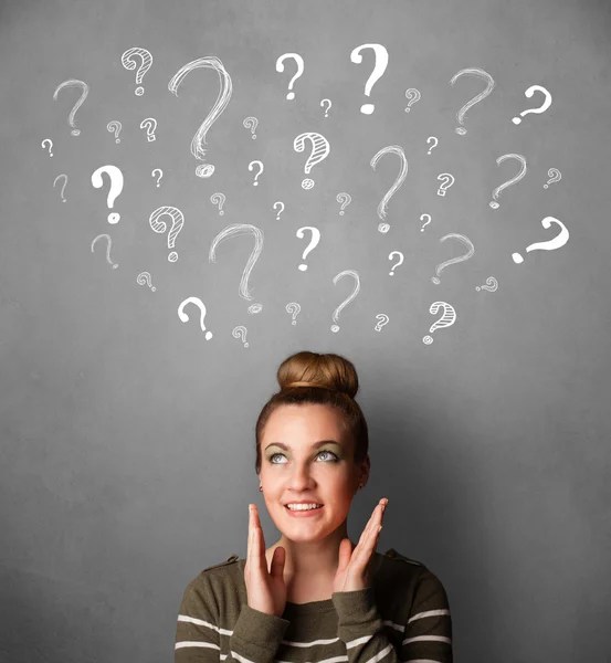 Young woman with question marks above her head — Stock Photo, Image