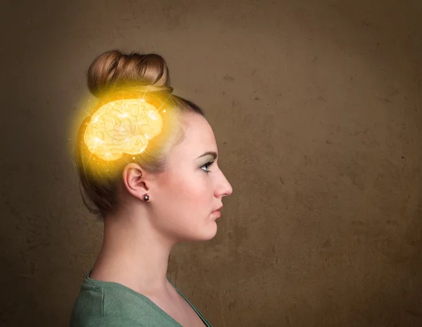 Young girl thinking with glowing brain illustration — Stock Photo, Image