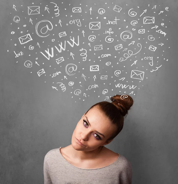 Young woman thinking with social network icons above her head — Stock Photo, Image