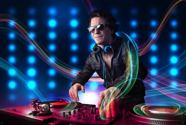 Young Dj mixing records with colorful lights — Stock Photo, Image