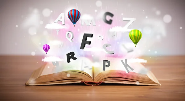 Open book with flying 3d letters on concrete background — Stock Photo, Image