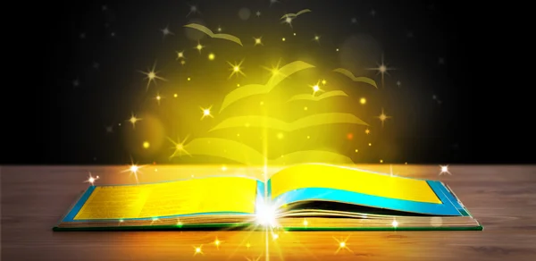 Open book with golden glow flying paper pages — Stock Photo, Image