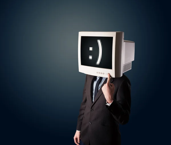 Funny young businessman with a monitor on his head and smiley on — Stock Photo, Image