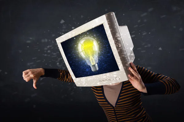 Girl with a monitor head, idea light bulb — Stock Photo, Image