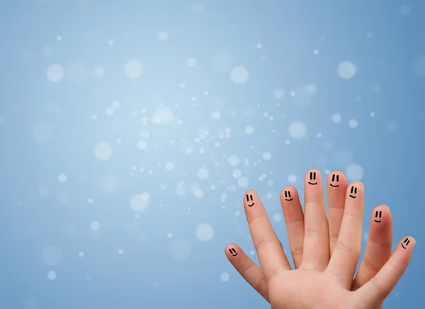 Sorrisos dedo feliz com fundo bokeh azul vazio — Fotografia de Stock