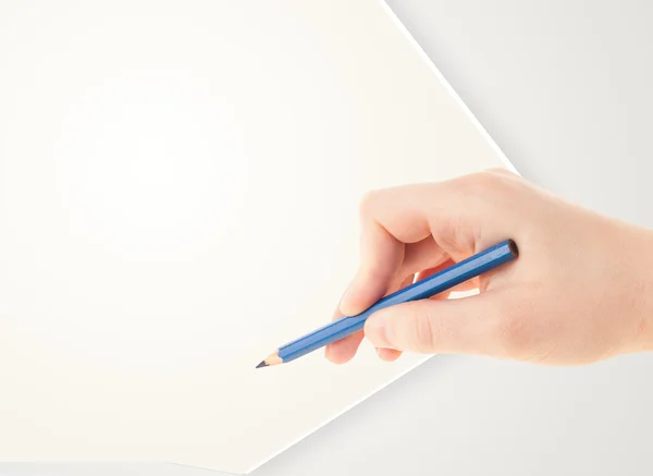 Human hand drawing with pencil on empty paper template — Stock Photo, Image