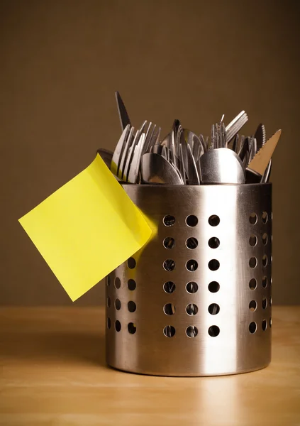 Empty post-it note sticked on cutlery case — Stock Photo, Image