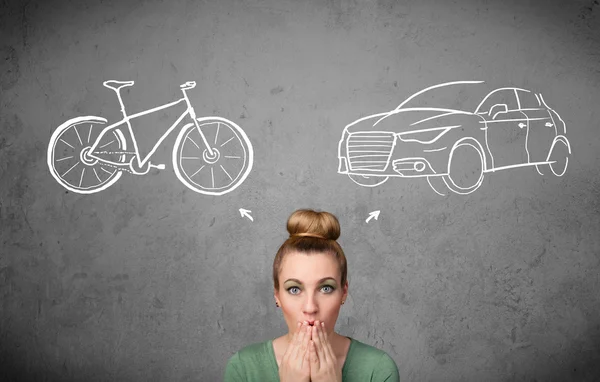 Woman making a choice between bicycle and car — Stock Photo, Image