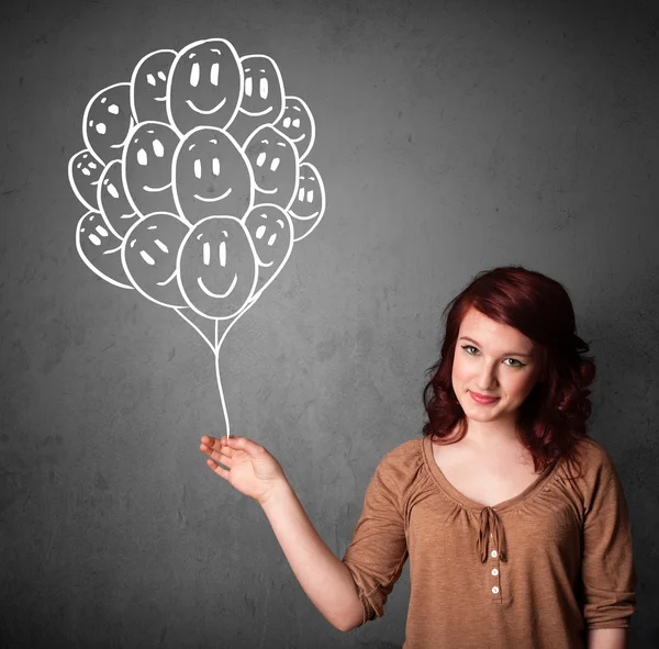 Woman holding a bunch of smiling balloons — Stock Photo, Image