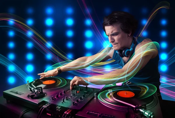 Young Dj mixing records with colorful lights — Stock Photo, Image