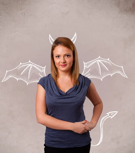 Young girl with devil horns and wings drawing — Stock Photo, Image