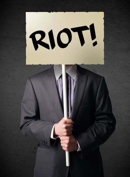 Businessman holding a protest sign — Stock Photo, Image