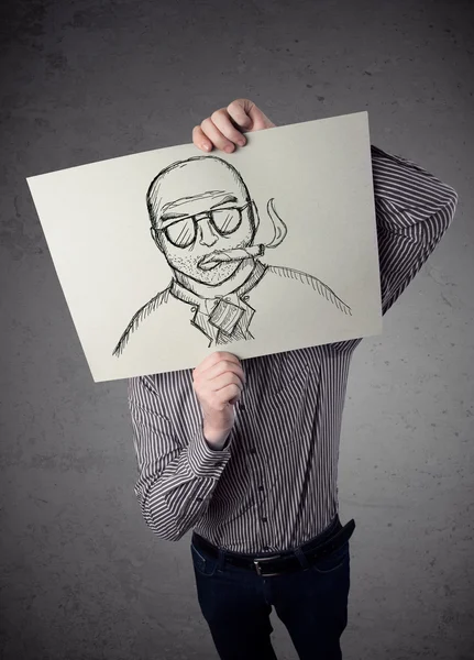 Businessman holding a cardboard with a smoking man on it in fron — Stock Photo, Image