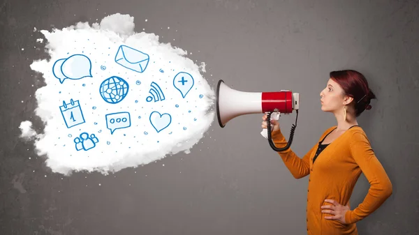 Woman shouting into loudspeaker and modern blue icons and symbol — Stock Photo, Image