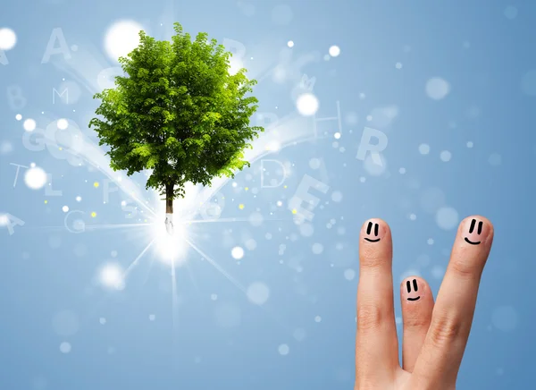 Happy finger smileys with green magical glowing tree — Stock Photo, Image