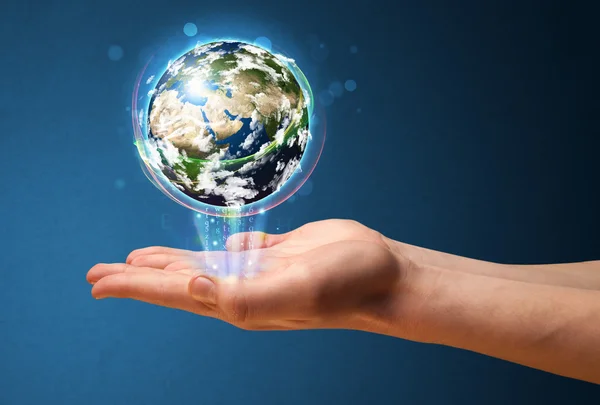 Businessman holding a glowing earth globe — Stock Photo, Image