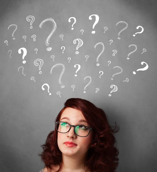 Young woman with question marks above her head — Stock Photo, Image