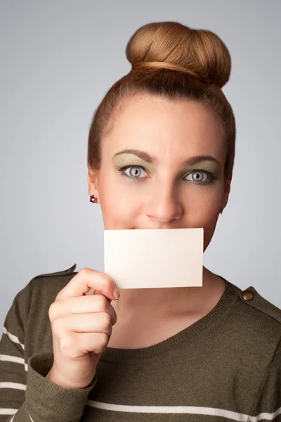 Cute girl holding white card at front of her lips with copy spac — Stock Photo, Image