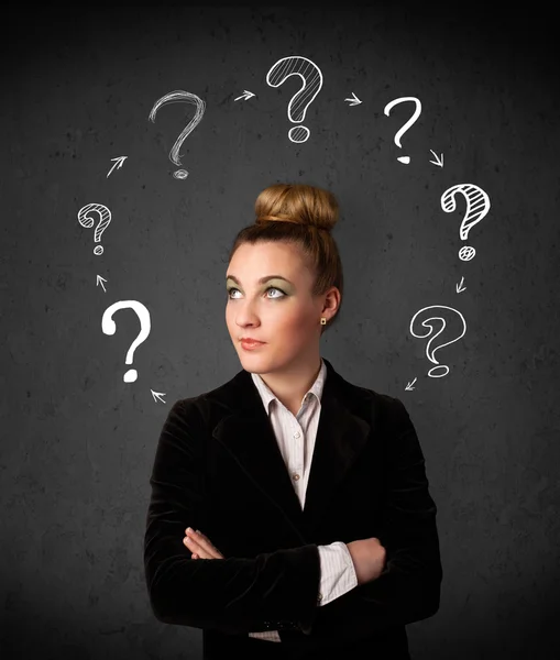 Young woman thinking with question mark circulation around her h — Stock Photo, Image