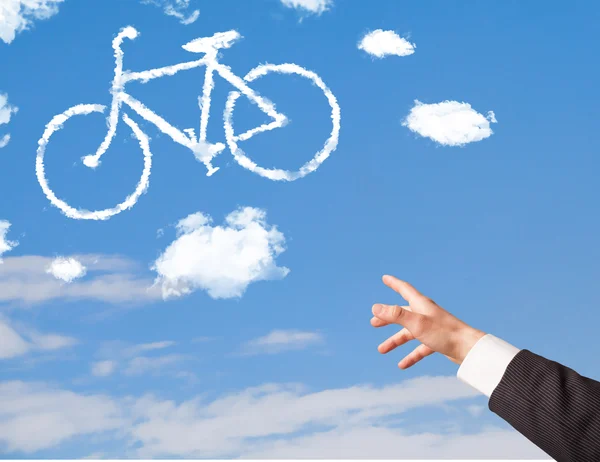 Hand zeigt auf Fahrradwolken am blauen Himmel — Stockfoto