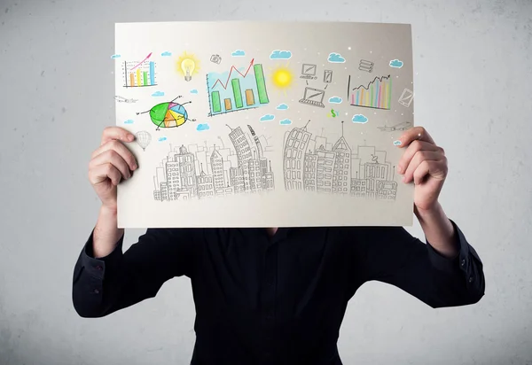 Businessman holding a paper with charts and cityscape in front o — Stock Photo, Image