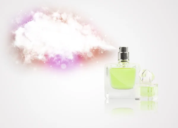 Beautiful bottle spraying colorful cloud — Stock Photo, Image