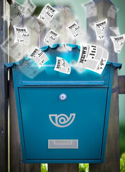 Post box with daily newspapers flying — Stock Photo, Image