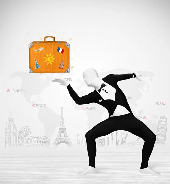 Man in full body suit presenting vacation suitcase — Stock Photo, Image