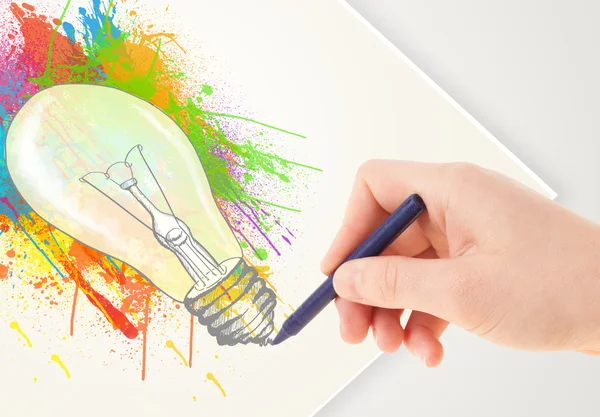 Hand drawing on paper a colorful splatter lightbulb — Stock Photo, Image