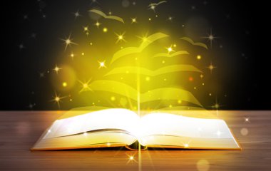 Altından parlak uçan kağıt sayfaları olan açık bir kitap